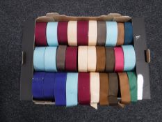 A box of spools of vintage hat trim