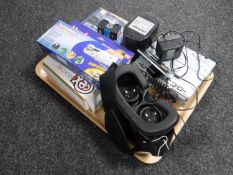 A tray containing virtual reality headset, car radio,