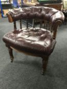 A Victorian oak buttoned leather horseshoe shaped chair