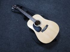 A Martin Smith left-handed acoustic guitar in carry bag