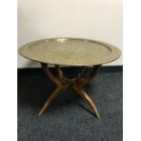 A folding Eastern brass topped table