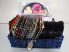 A basket containing a quantity of vinyl 35 singles mainly 1980's including Wham, Human League,