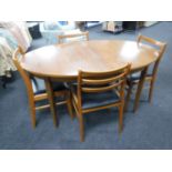 A 1970's oval teak extending dining table and four chairs