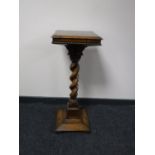 An early 20th century oak barley twist column plant stand