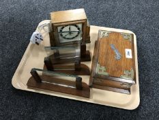 An Edwardian oak cigarette box together with and oak mantle clock and stands