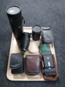 A tray of four cameras including Helina, Kodak, camera lenses,