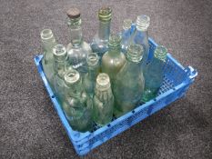 A crate of antique glass bottles