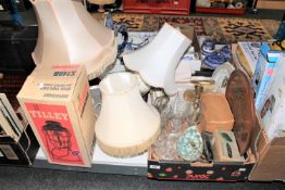 A boxed Tilley Stormlight, various table lamps and a box of glass ware,
