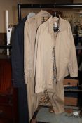 Two Burberry three quarter length coats together with a Burberry jacket