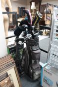 A McGregor golf bag containing assorted irons and drivers, folding golf trolley,