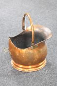 A copper swing-handled coal bucket