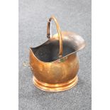 A copper swing-handled coal bucket