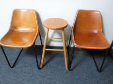 A pair of 20th century leather chairs and a pine stool