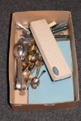 A box of boxed and unboxed flatware