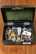 A small jewellery casket of costume jewellery, Chinese jade pendant, white metal chains,
