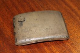 A curved silver cigarette case with engine turned decoration