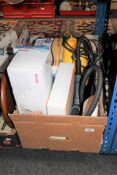 A box containing Beurer massager, clothes steamer, boxed vacuum,