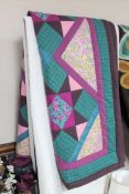 A Durham quilt together with a patchwork quilt