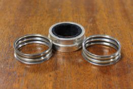 A pair of silver napkin rings together with one other sterling silver napkin ring (3)