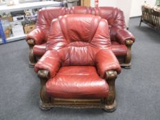 A wood framed Burgundy leather three seater settee and armchair