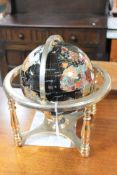 A gemstone globe on brass stand,