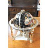 A gemstone globe on brass stand,