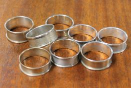 A non-matched suite of eight silver napkin rings - mostly Birmingham mid 1980's.