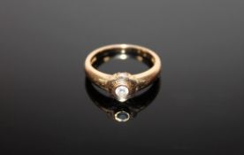 An 18ct gold ring set with a .15 solitaire diamond, 4.