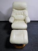 A cream leather swivel armchair and footstool