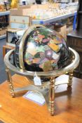 A gemstone globe on brass stand,