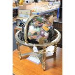 A gemstone globe on brass stand,