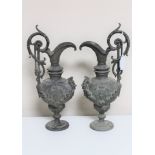 A pair of antique ornate cast metal ewers (2)