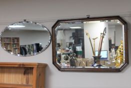 An Edwardian octagonal oak framed mirror and an un-framed mirror