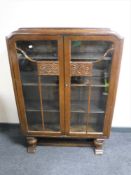 An early 20th century oak double door glazed bookcase