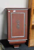 A painted single door wall cabinet