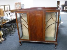 A mahogany side by side display cabinet on claw and ball feet
