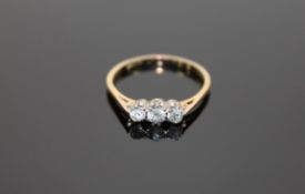 An 18ct gold three stone diamond ring, size O.