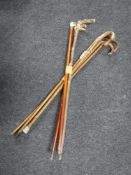 Two bundles of walking sticks including one horn handled example with silver mount and one with
