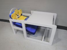 A child's desk together with a boxed Mamas & Papas bassinet
