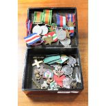 A lacquered box containing a collection of un-named WWII medals, foreign medals,