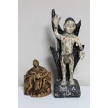 An antique carved painted wooden religious figure together with one other similar carving.
