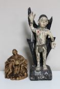 An antique carved painted wooden religious figure together with one other similar carving.