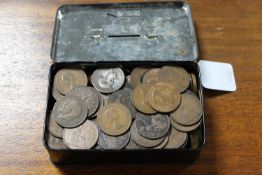 A vintage cash tin containing pre-decimal pennies