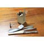 A small pot containing silver handled button hook and shoe horn, glove stretchers,