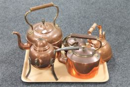 A tray of copper kettles/tea pots