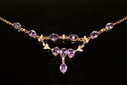 An antique yellow metal necklace set with amethyst and seed pearls