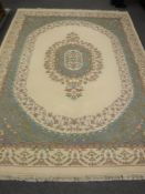 A Chinese floral carpet on cream ground,