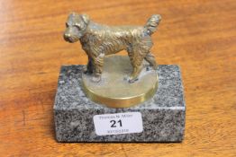 A bronze car mascot in the form of a dog,