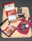 A tray of costume jewellery, enamel badges, silver toothpick,