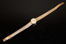 A Sakata 18ct yellow gold lady's wrist watch on two-tone strap 27.4g gross.